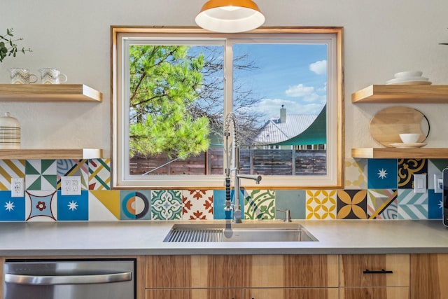 kitchen featuring tasteful backsplash, sink, and stainless steel dishwasher