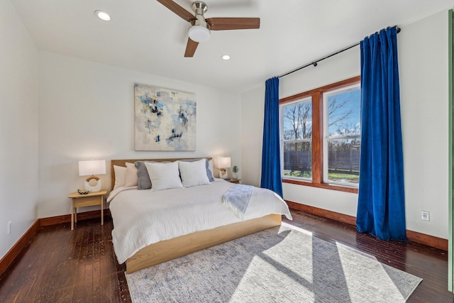 bedroom with dark hardwood / wood-style floors and ceiling fan