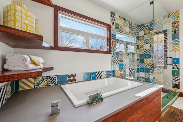 bathroom with a tub to relax in and hardwood / wood-style floors