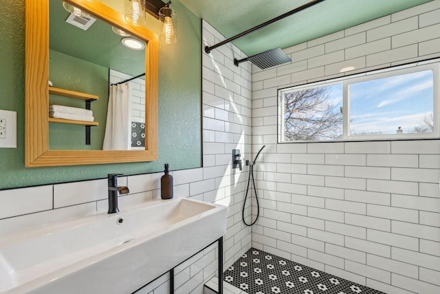 bathroom with sink, decorative backsplash, and a shower with curtain