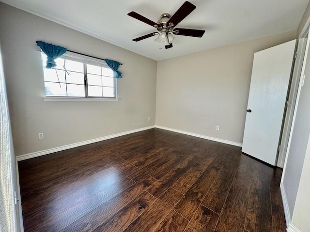 empty room with baseboards, a ceiling fan, and wood finished floors