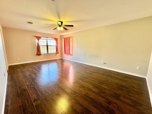 empty room featuring dark hardwood / wood-style floors and ceiling fan