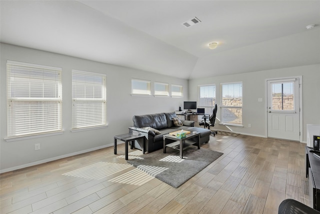 living room featuring lofted ceiling