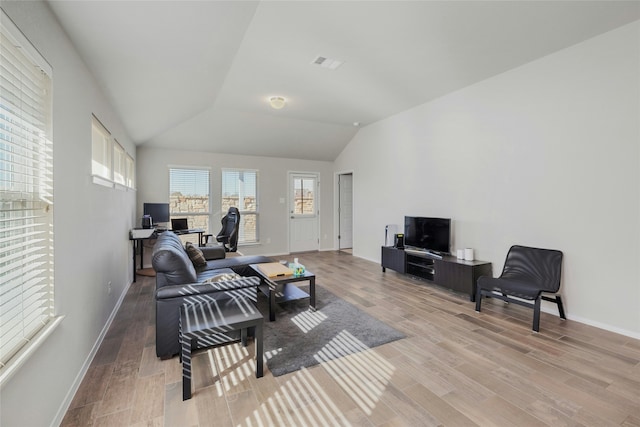 living room with lofted ceiling and light wood-type flooring