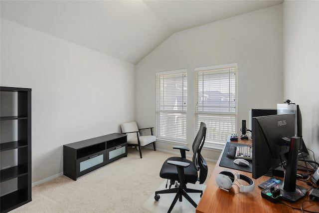 carpeted office space featuring lofted ceiling and plenty of natural light