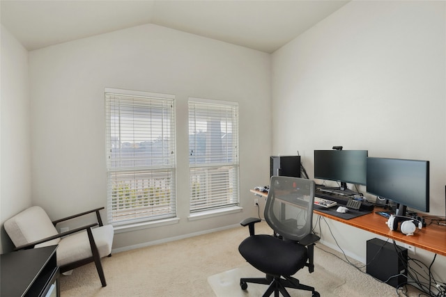 carpeted office space with vaulted ceiling