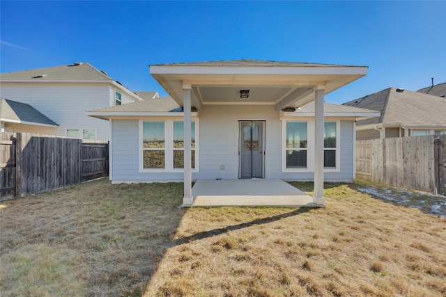 back of property featuring a patio and a lawn