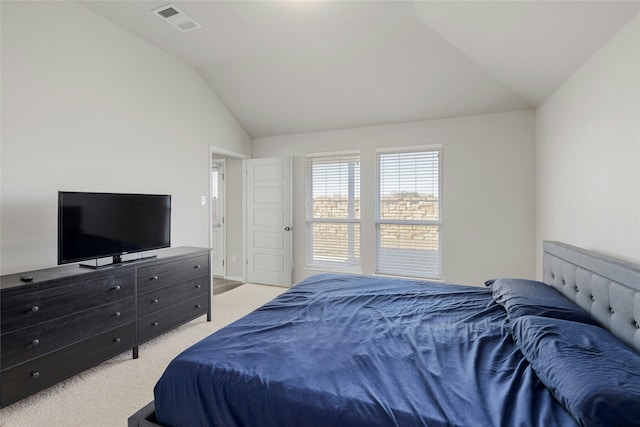 bedroom with vaulted ceiling and light colored carpet