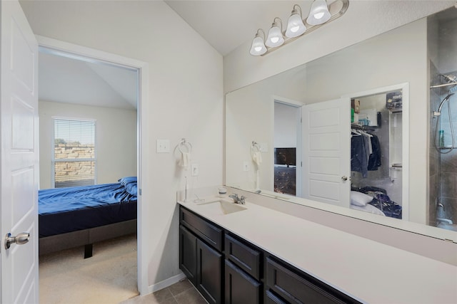 bathroom featuring vanity, tile patterned flooring, and vaulted ceiling