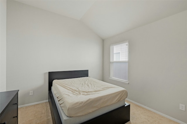 carpeted bedroom with vaulted ceiling