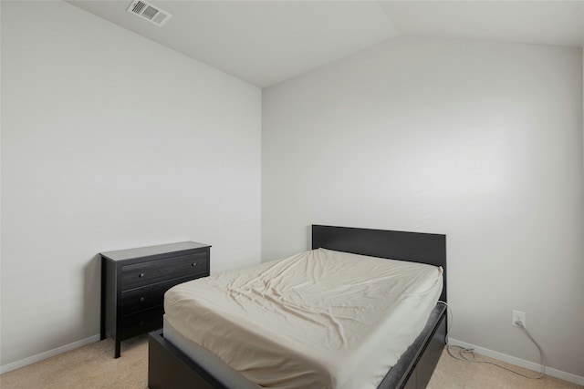 carpeted bedroom featuring vaulted ceiling