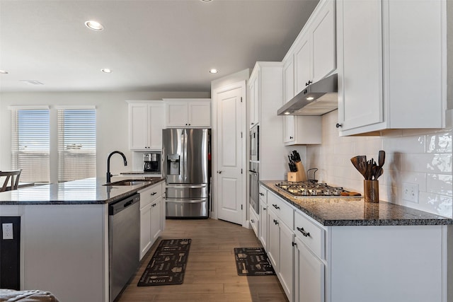 kitchen featuring sink, white cabinetry, tasteful backsplash, dark hardwood / wood-style floors, and stainless steel appliances