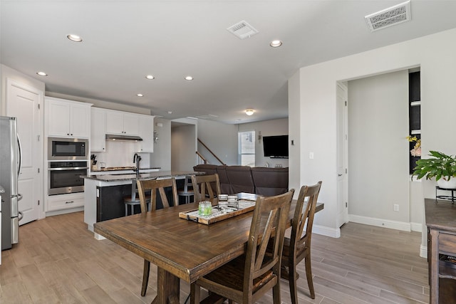 dining room with light hardwood / wood-style flooring