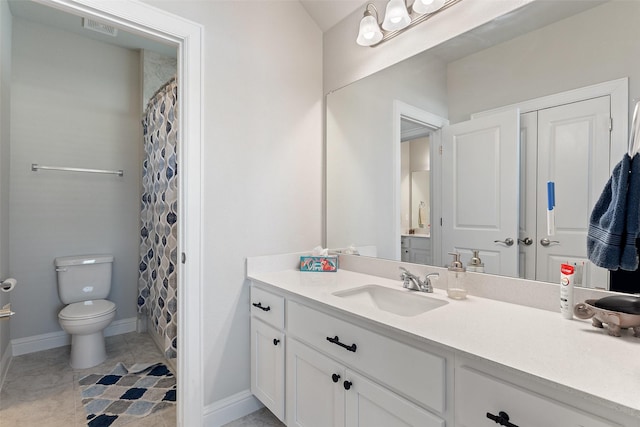 bathroom featuring vanity, tile patterned flooring, and toilet