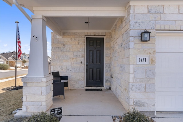 view of exterior entry with a porch