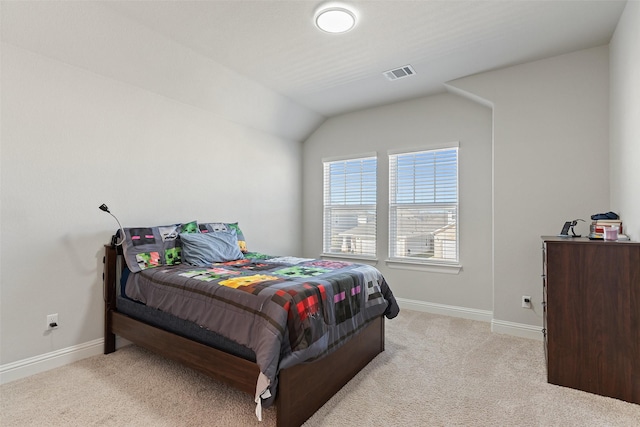 bedroom with lofted ceiling and light colored carpet