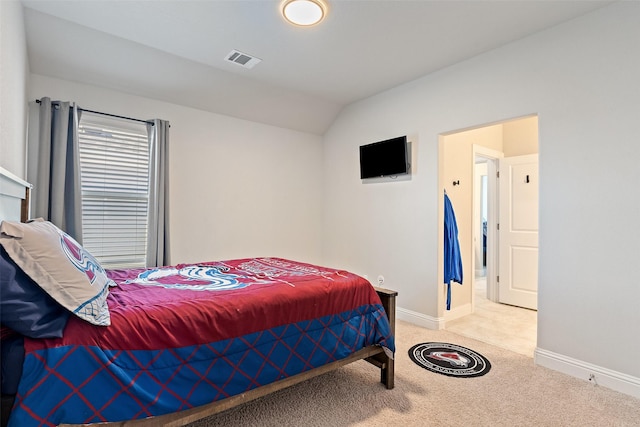 carpeted bedroom featuring lofted ceiling