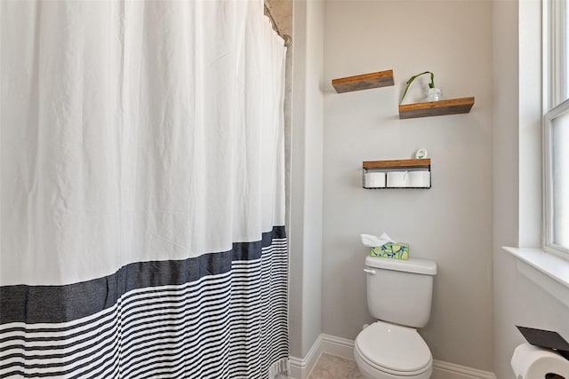 bathroom with toilet and a wealth of natural light