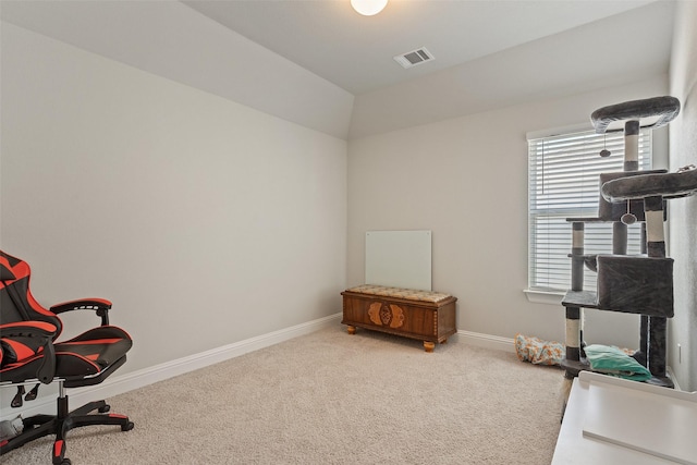 carpeted office space featuring vaulted ceiling