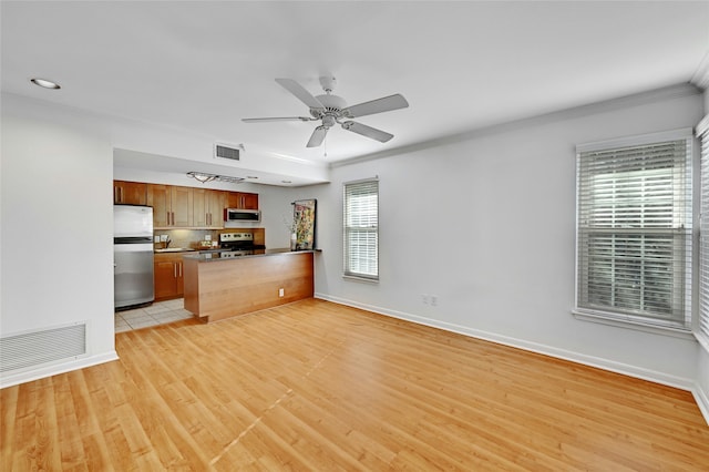 kitchen featuring sink, light hardwood / wood-style flooring, stainless steel appliances, and plenty of natural light