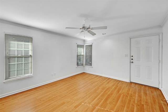 unfurnished room with crown molding, light wood-type flooring, and ceiling fan