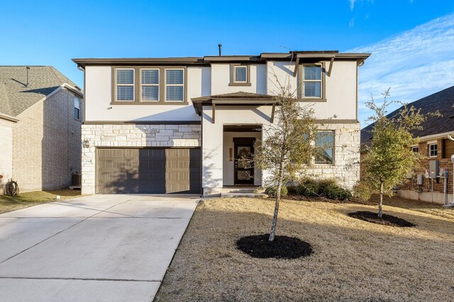 view of front of house with a garage and central AC unit