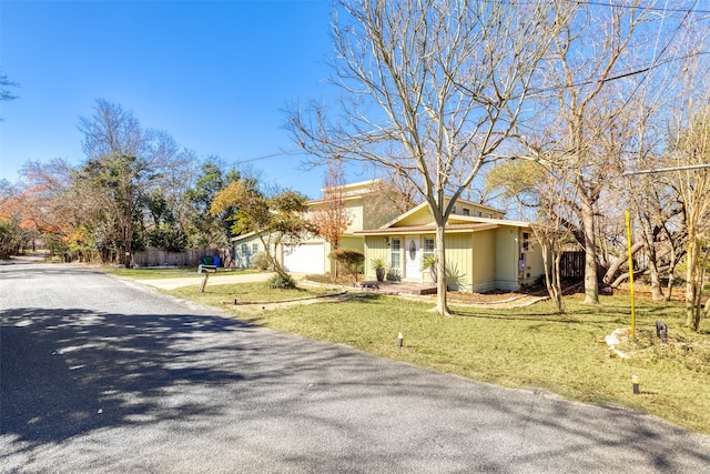 view of front of home with a garage and a front lawn