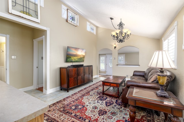 living room with a chandelier and a textured ceiling