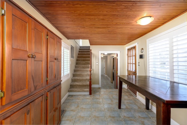 interior space featuring light tile patterned floors and wood ceiling