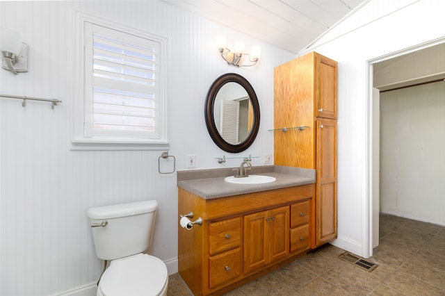 bathroom with crown molding, vanity, and toilet