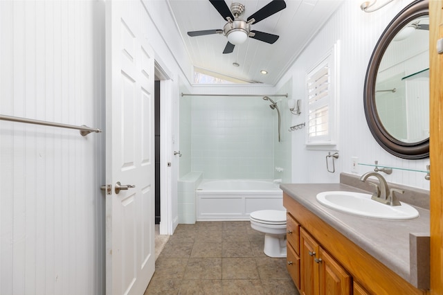 full bathroom featuring tiled shower / bath, lofted ceiling, vanity, ceiling fan, and toilet