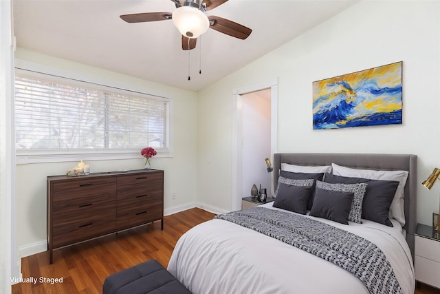 bedroom with ceiling fan, dark hardwood / wood-style flooring, and vaulted ceiling