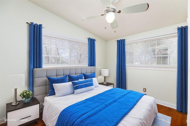 bedroom with lofted ceiling, dark wood-type flooring, and ceiling fan