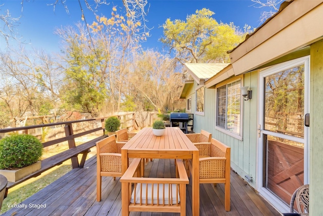 wooden terrace featuring a grill