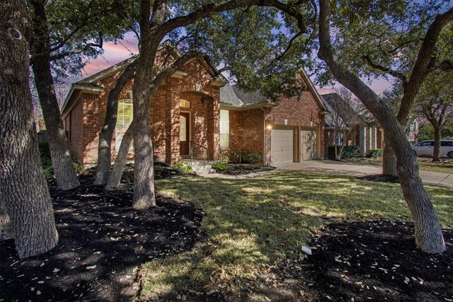 view of front of house with a garage and a lawn