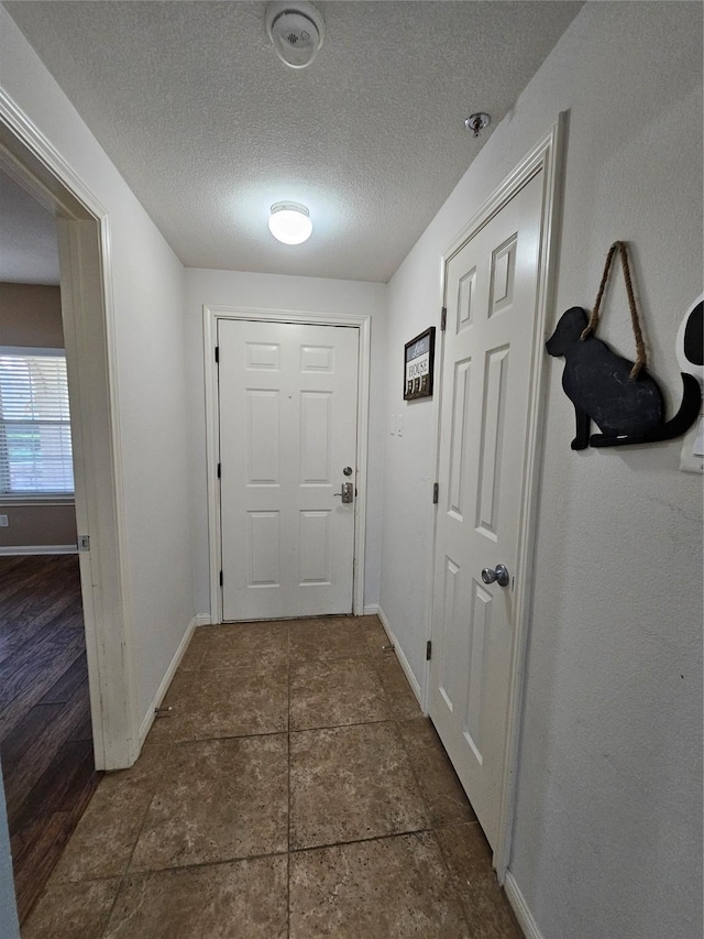 doorway with a textured ceiling