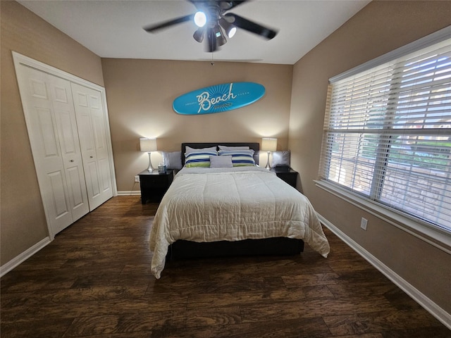 bedroom featuring dark hardwood / wood-style flooring, ceiling fan, and a closet