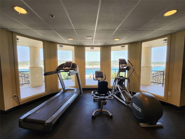 workout area with expansive windows and a water view