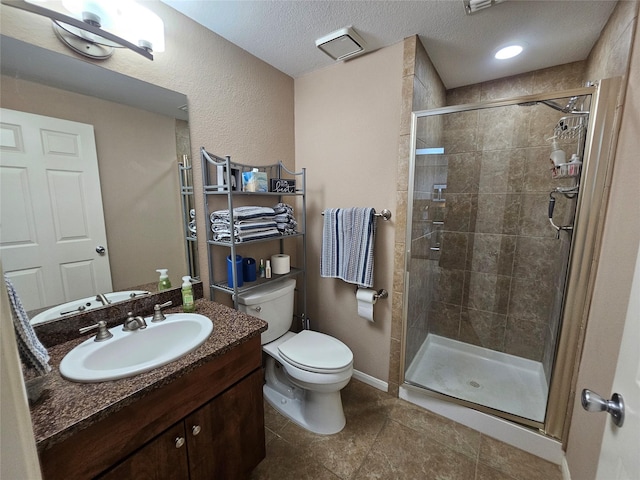 bathroom with an enclosed shower, vanity, a textured ceiling, and toilet