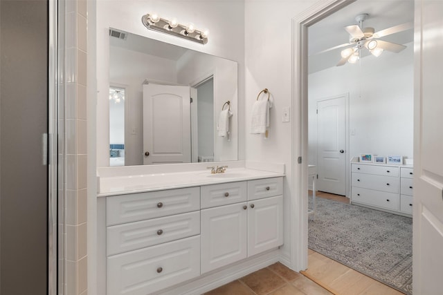 bathroom with ceiling fan, wood-type flooring, and vanity