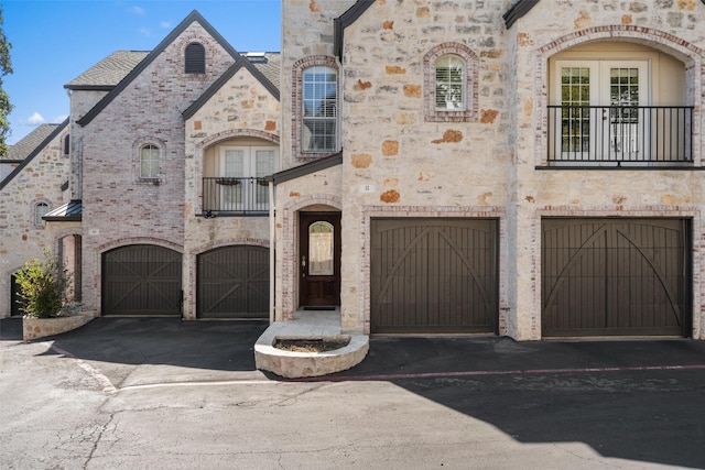 french country style house with a garage and french doors