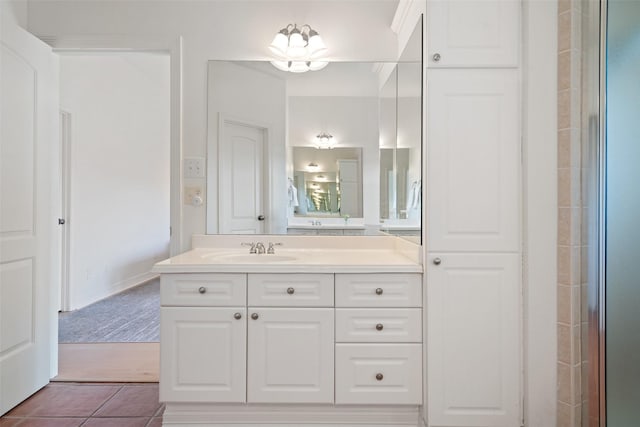 bathroom featuring tile patterned floors, vanity, and a shower with door