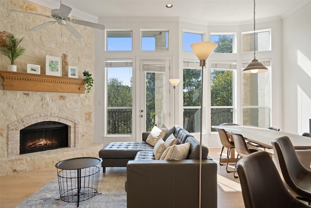 living room featuring crown molding, ceiling fan, and hardwood / wood-style flooring