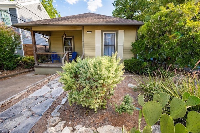 view of exterior entry with covered porch