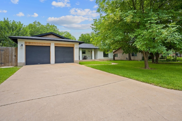 view of front of home with a garage and a front yard