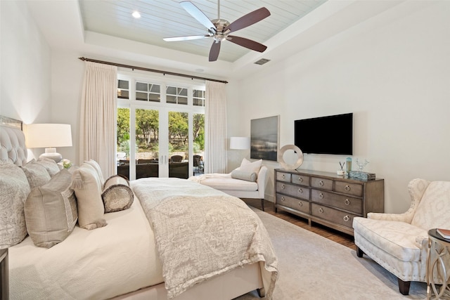 bedroom featuring hardwood / wood-style flooring, access to outside, ceiling fan, a raised ceiling, and wooden ceiling