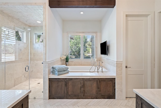 bathroom featuring vanity, beam ceiling, and independent shower and bath