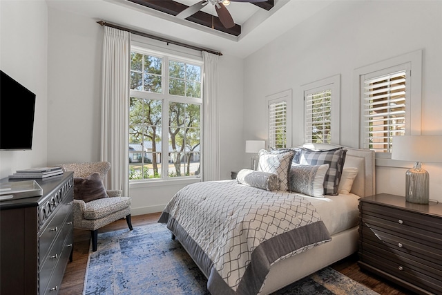 bedroom with ceiling fan, dark hardwood / wood-style floors, and multiple windows