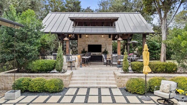 view of patio / terrace with an outdoor stone fireplace