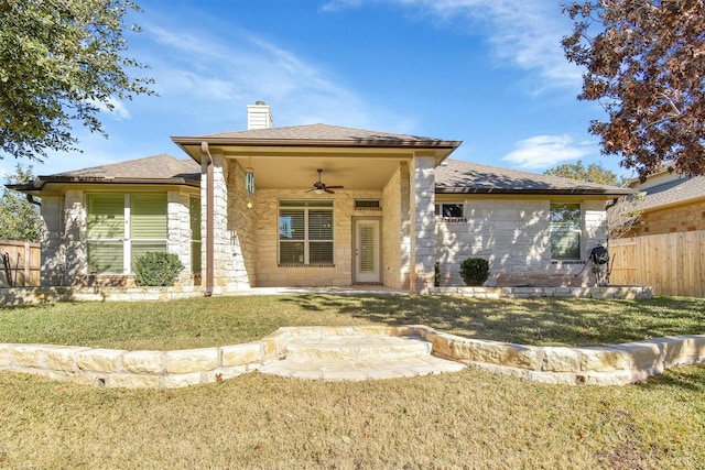 view of front of property with a front yard and ceiling fan